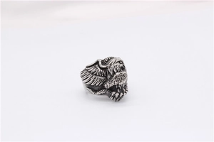 Detailed close-up of a vintage eagle relief on a men's stainless steel ring