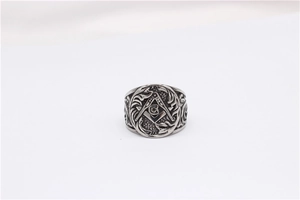 Close-up of vintage silver Masonic ring with compass symbol and ornate side engravings