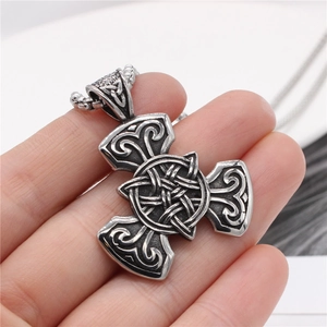 Men's Viking Celtic knot pendant in vintage silver steel finish held by hand