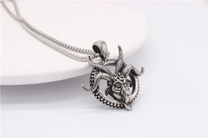 Close-up of vintage steel ram head pendant with pentagram detail and aged silver finish