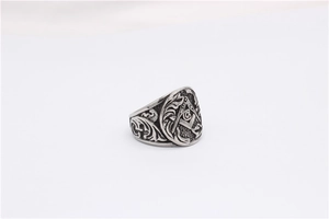 Close-up of vintage silver Freemason steel ring with Masonic G symbol and baroque relief