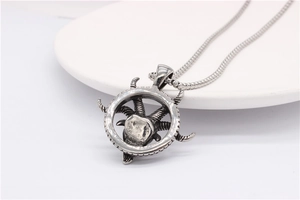 Macro shot of vintage silver ram head pendant with antique finish and steel chain