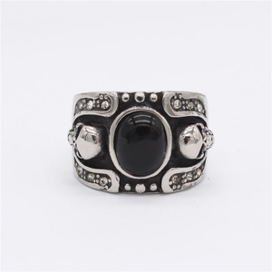 Retro gothic skull ring with large black gemstone and cubic zirconia accents in steel
