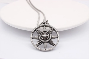 Macro view of retro all-seeing eye pendant on round steel disk with radial pattern