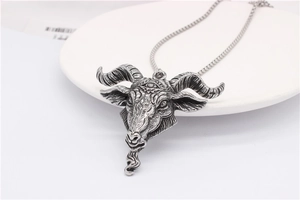 Macro shot of gothic ram head pendant with mystic eye carving in vintage steel