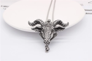 Macro shot of retro stainless steel ram head pendant with intricate devil eye carvings