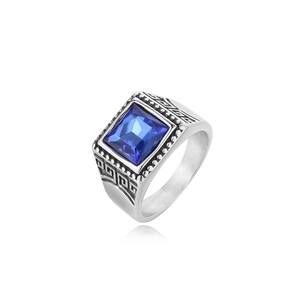 Macro detail of men's titanium ring featuring square blue gemstone and Greek key pattern