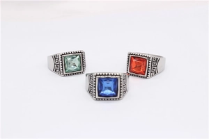 Detail of square-cut colorful gemstones on vintage rings with Greek Key patterns