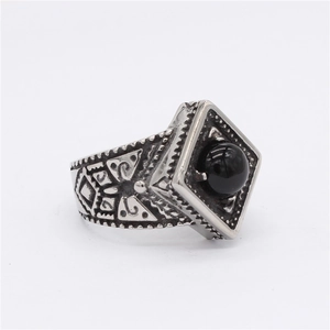 Vintage silver-tone titanium ring featuring a black gemstone and geometric engraving