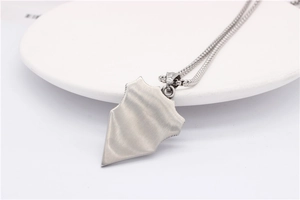 Detail of brushed titanium steel shield pendant for men with silver pearl chain