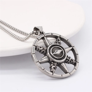 Vintage silver all-seeing eye round pendant necklace with star motif on ceramic dish