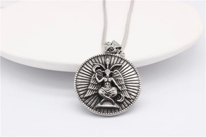Macro shot of vintage Baphomet relief pendant on a silver-toned stainless steel chain