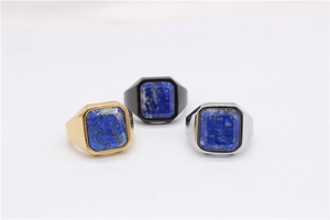 Detailed view of square-cut blue lapis lazuli stone in gold, black, and silver signet rings
