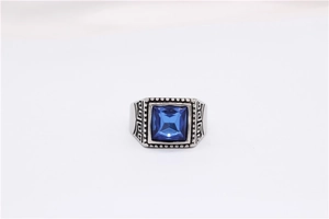 Detail of vintage steel ring with blue square gemstone and Greek key patterns
