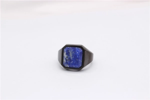 Close-up of men's black titanium ring featuring a rectangular lapis lazuli stone inlay
