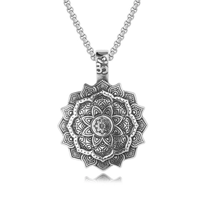 Macro detail of vintage silver mandala pendant with intricate floral engravings and Om symbol