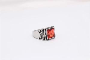 Detailed macro view of vintage men's ring with red gemstone and Greek key patterns