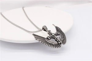 Macro view showing detailed wing textures and antique silver finish on a cross pendant