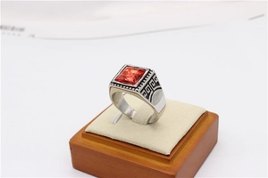 Detail view of vintage men's steel ring with rectangular red gemstone and engraved patterns