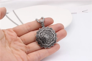Detail of vintage lotus mandala pendant in silver finish showing intricate layered metalwork