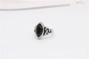 Detailed macro view of Celtic knot design and marquise black gemstone on the silver ring