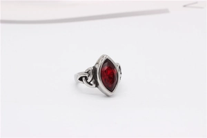 Macro shot of Viking Celtic knot ring featuring a large marquise cut red gemstone inlay