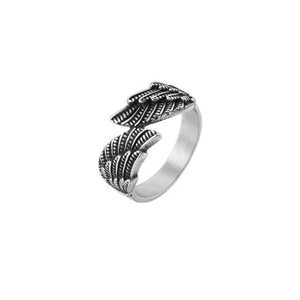 Macro shot of vintage silver angel wing ring with detailed feather texture in titanium steel