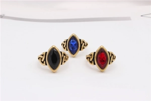 Close-up of vintage gold rings featuring marquise gemstones and Celtic knot patterns