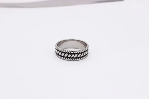 Macro shot of vintage titanium steel ring with textured rope pattern and engraved edges