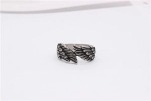 Close-up of vintage feather wings texture on adjustable stainless steel ring band