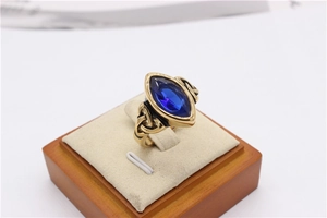 Macro view of blue marquise gemstone and intricate Celtic knot details on gold ring