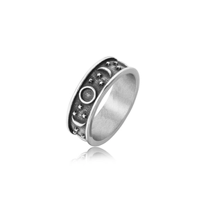 Macro detail of retro celestial relief ring with moon and star patterns in silver