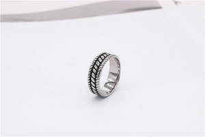 Macro shot of retro stainless steel ring featuring vintage braided wheat pattern details