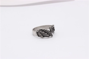 Detailed macro shot of vintage silver steel wing ring showing intricate feather textures