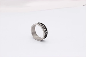 Macro shot of retro star and moon engravings on a vintage titanium steel ring band