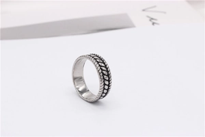 Detailed macro view of vintage titanium steel ring with intricate double-row braided texture