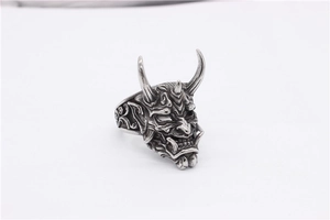 Macro detail of gothic demon mask ring with vintage oxidized finish and intricate horns