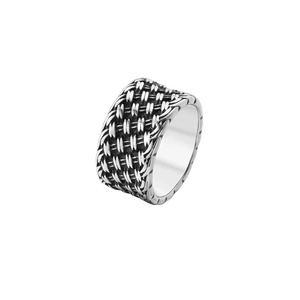 Macro shot of silver woven knot texture on a vintage stainless steel wide band ring
