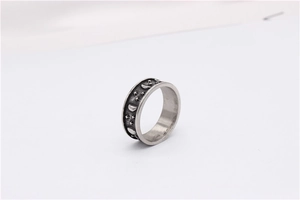 Macro shot of retro star and moon relief pattern on antique silver titanium steel ring