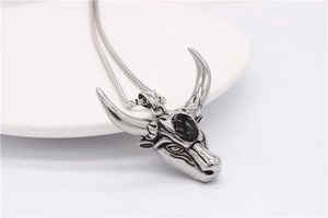 Detailed close-up of retro stainless steel bull head pendant with black onyx gemstone
