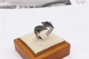 Detailed macro view of vintage silver eagle wings on an adjustable steel thumb ring