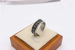 Detailed view of vintage star and moon relief patterns on matte titanium steel ring
