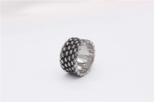 Detail of retro braided texture and blackened finish on stainless steel wide ring band