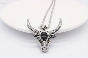 Detailed view of ram bull head pendant in silver titanium steel with black stone inlay