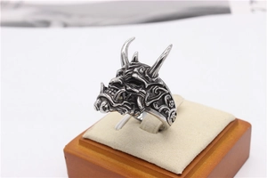 Macro view of vintage silver horned skull ring with intricate antique finish on a stand