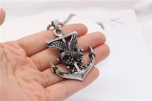 Detailed close-up of retro punk anchor and eagle pendant necklace in aged titanium steel