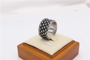 Detailed close-up of the vintage woven steel texture on this wide retro band ring