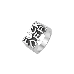 Macro shot of silver titanium steel ring featuring bold FUCK OFF embossed lettering