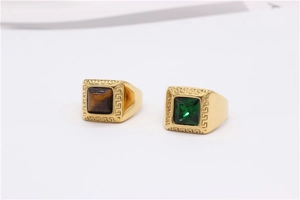 Detail of square signet rings with tiger eye stone, green crystal, and Greek key patterns