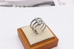 Detail view of silver triple-layered stainless steel ring on a jewelry display stand